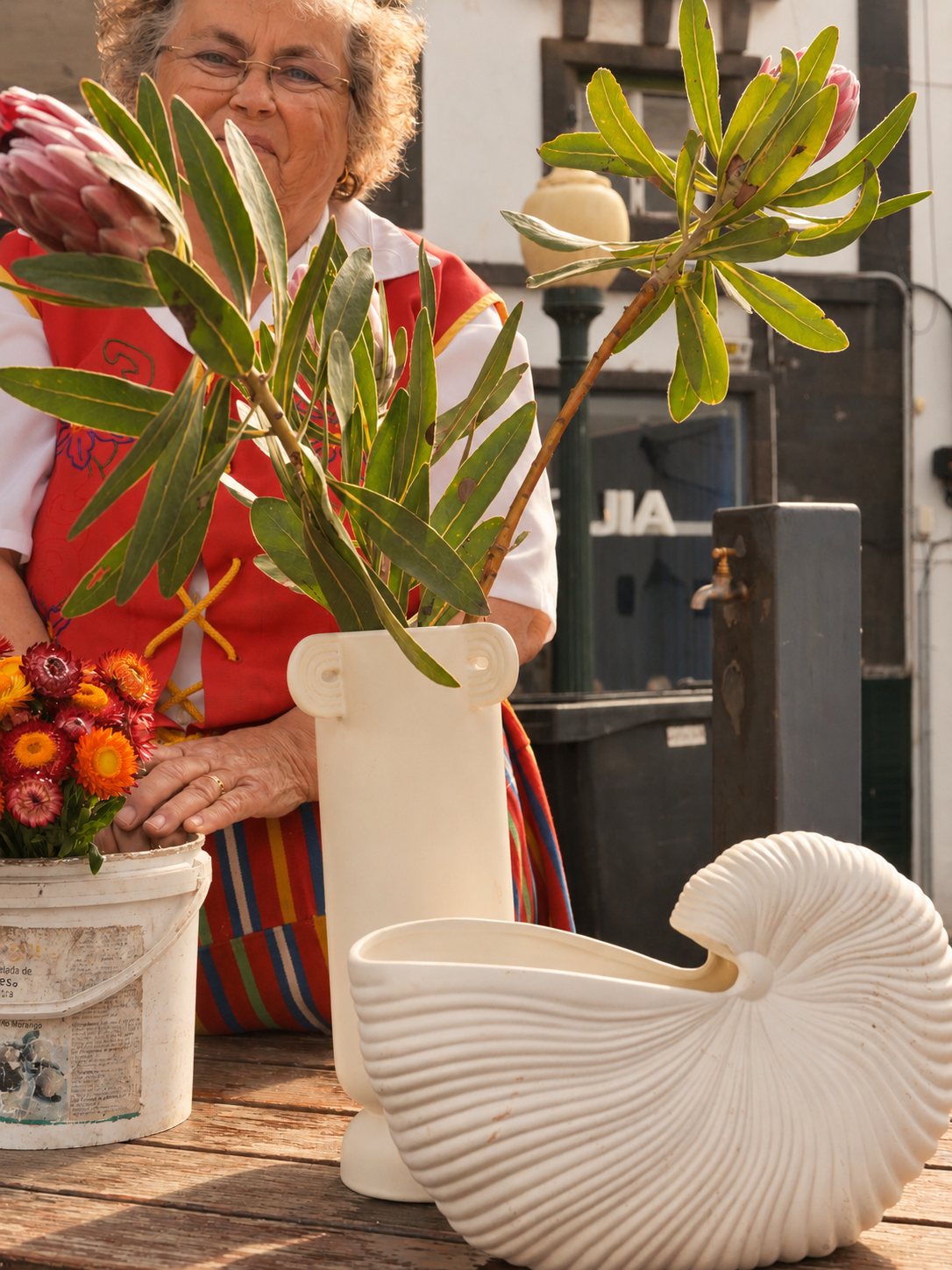 Flower seller in traditional Madeiran dress with ferm LIVING vases